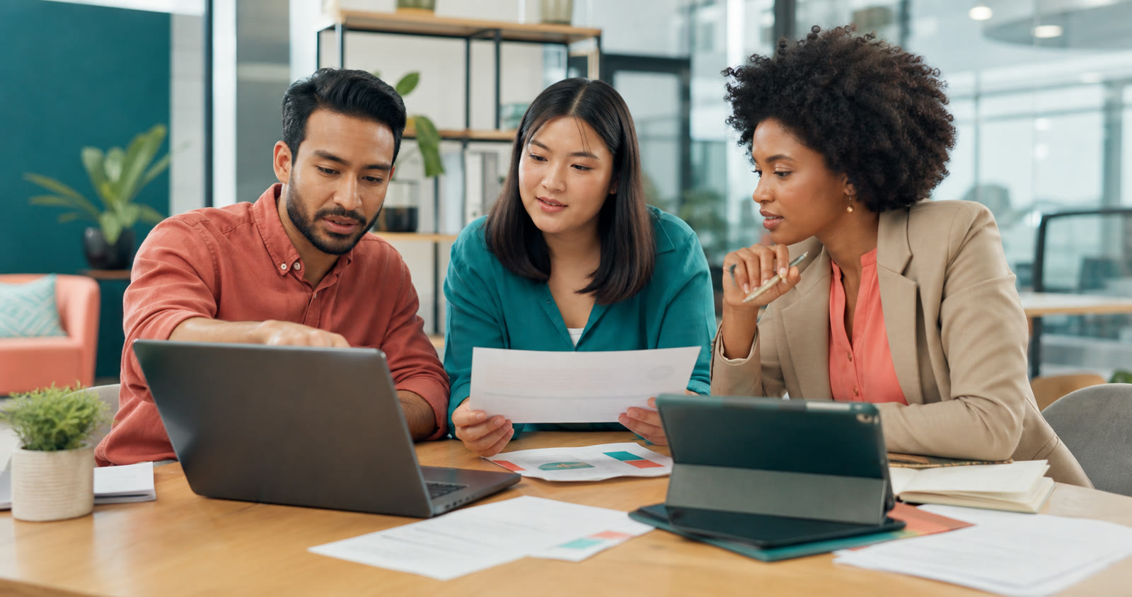 HR and learning professionals using a company document to plan interactive digital employee training